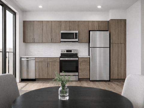 A modern kitchen with a black table and stainless steel appliances.